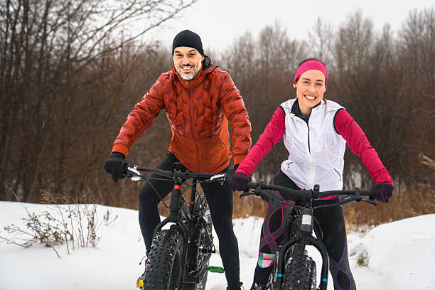 istock Couple Mountain Biking on Fat Bikes in the winter 2248202447