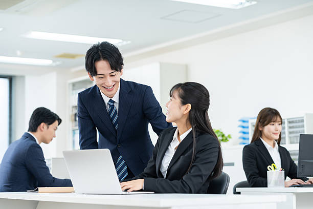 istock Young men and women working in the office 2248202679