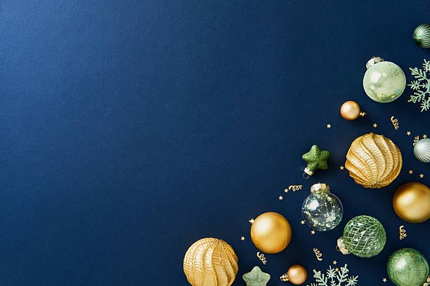 istock Luxurious gold and green Christmas baubles on navy blue background. 2248203789