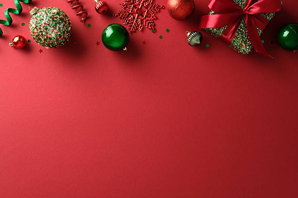 istock Christmas banner background with red and green baubles, confetti, and gift box. Flat lay. 2248203861