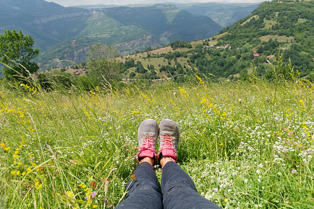Woman's legs on summer mountain background