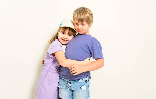 Cute girl share love with lovely boy in public park