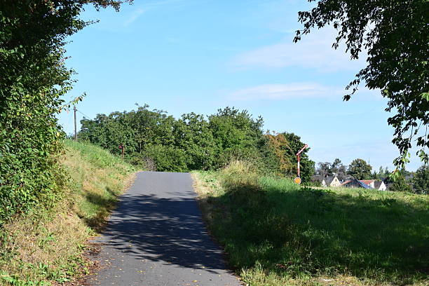 istock steep farm road up to a railway 2248205335