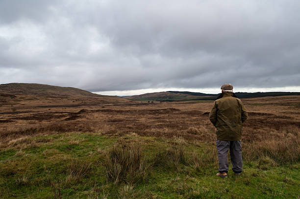istock Farmer looking at uncultivated land in rural Scotland 2248205425