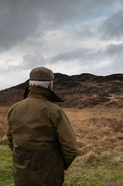 istock Farmer looking at livestock on a distant hill 2248205494
