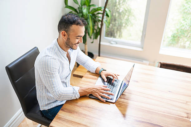istock Portrait young mexican attractive businessman working at modern home office with computer laptop 2248207375