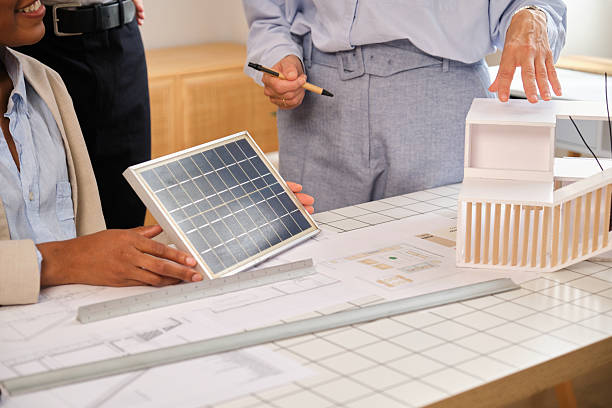 istock Architects designing sustainable building with solar power model 2248208802
