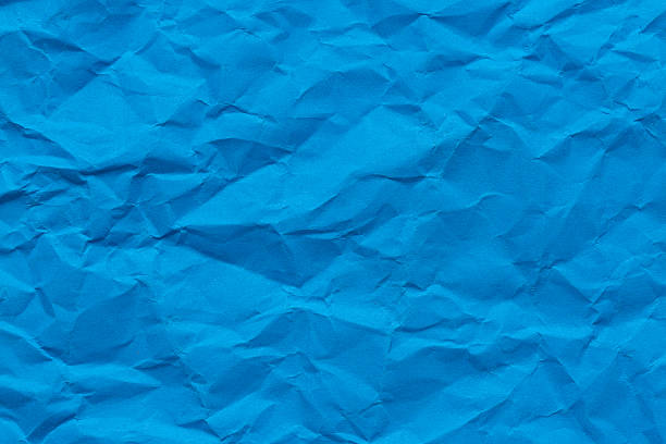 istock Close-up macro crumpled blue paper background,Abstract blue paper texture as background. Texture of slightly crumpled craft paper. Paper background. Recycled blue paper backdrop in close up. blue Textures. Wallpaper. 2248211408