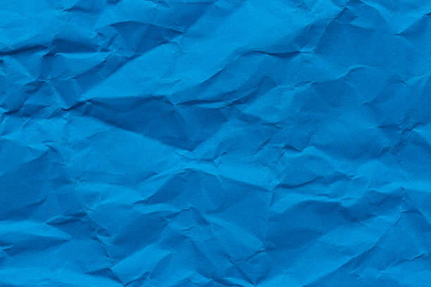 istock Close-up macro crumpled blue paper background,Abstract blue paper texture as background. Texture of slightly crumpled craft paper. Paper background. Recycled blue paper backdrop in close up. blue Textures. Wallpaper. 2248211427