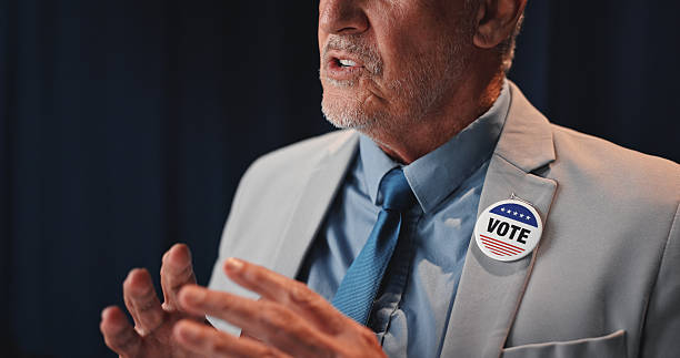 Hands, man and political speech at convention for democracy, press conference and election campaign. Mature politician, discussion and vote badge for government, public announcement and media debrief