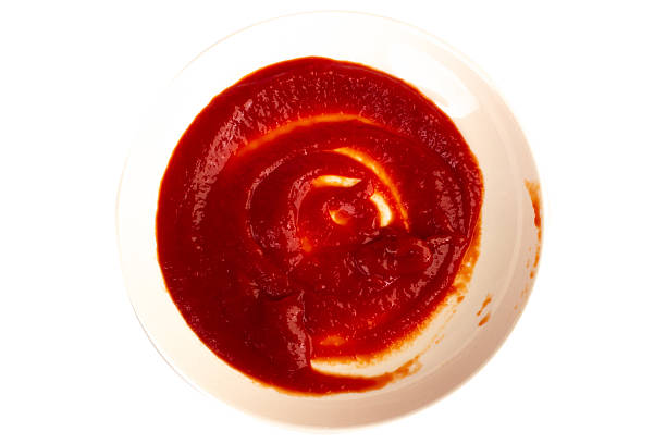 istock Ketchup splashing on a white plate on white background 2248212642