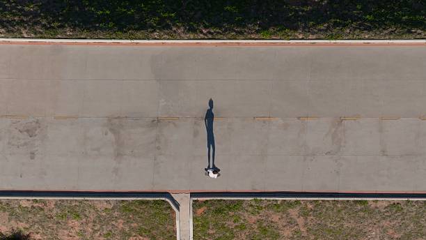 istock Top View of a Young Adolescent Skateboarding at a Boardwalk 2248212821