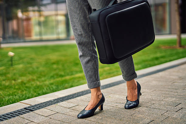 istock Businesswoman walking outdoors carrying briefcase for job interview 2248213109