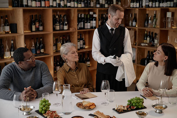 istock Multiethnic Adults Observing Sommelier Presenting Wine Bottle for Tasting 2248214006
