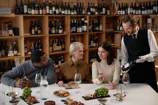 istock Diverse Group of Adults Tasting Wine with Sommelier in Wine Cellar Setting 2248214026