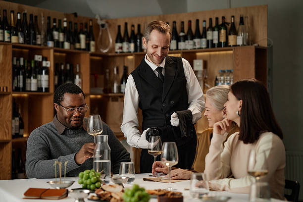 istock Diverse Group of Adults Tasting Wine with Sommelier in Modern Wine Cellar 2248214117