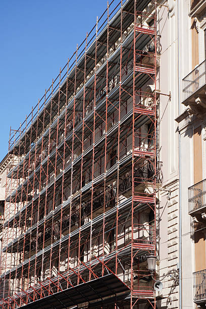 istock Scaffold for Building Construction. Residential Building Under Construction with Scaffolding. Scaffolding surrounding residential development in Sicily, Italy for safe access to construction work. 2248214201