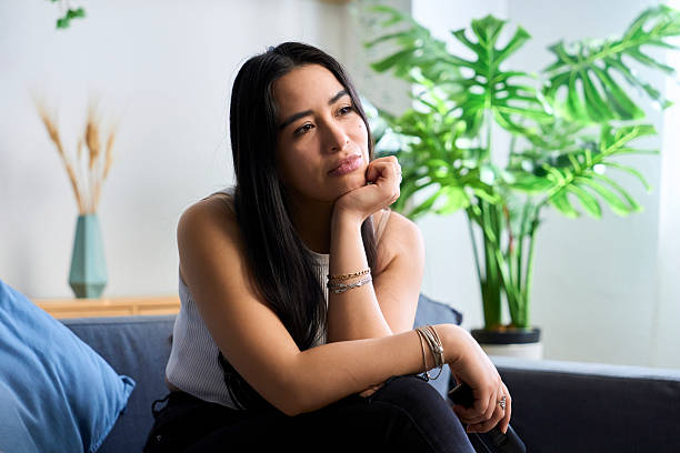 Young woman thinking while resting hand on chin