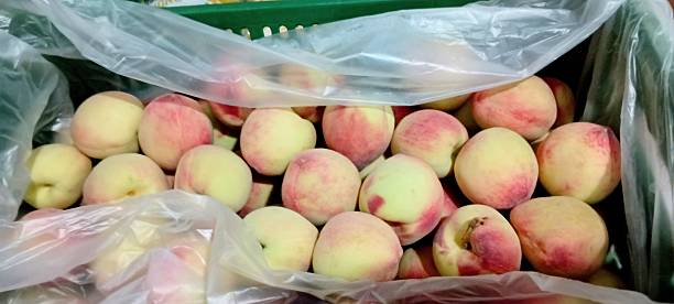 istock photograph of peaches on a stall 2248218594