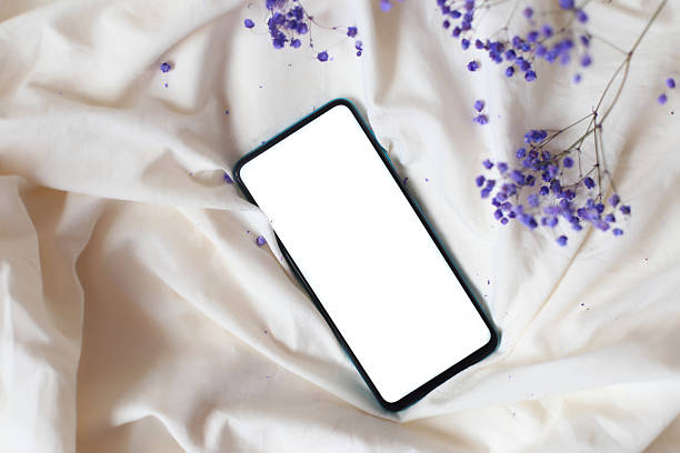 istock Mock up phone on the bed top view 2248219491