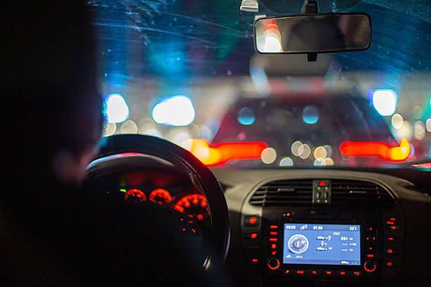 istock Driver in car waiting in city night traffic 2248220998