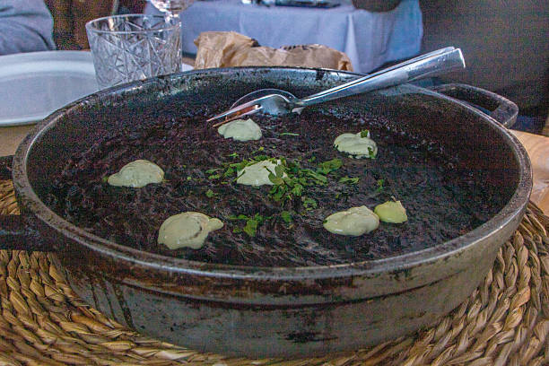 arroz negro or black paella made  with squid ink , typical spanish recipe