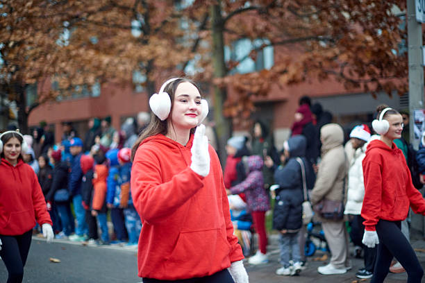 Toronto, Ontario, Canada—November 23rd, 2025: A girl waving to the crowd during Toronto’s annual Santa Claus Parade.