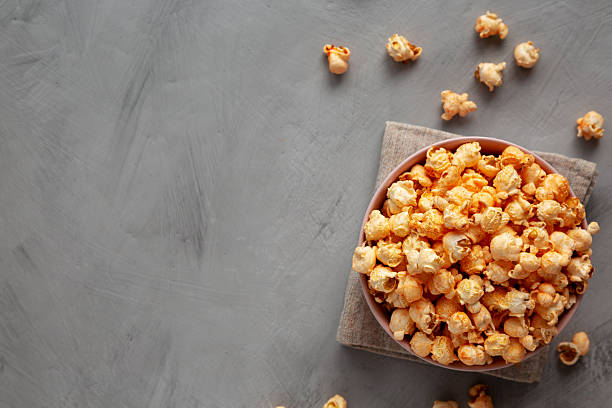 istock Homemade Cheese Popcorn in a Bowl on a gray background, top view. 2248227398
