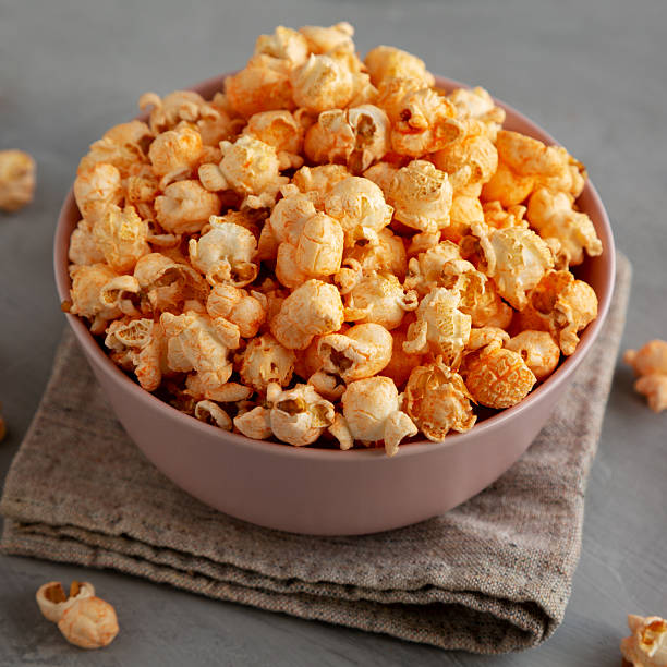 istock Homemade Cheese Popcorn in a Bowl on a gray background, side view. 2248227525