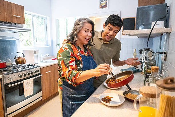 istock Mature couple cooking together in the kitchen 2248232589