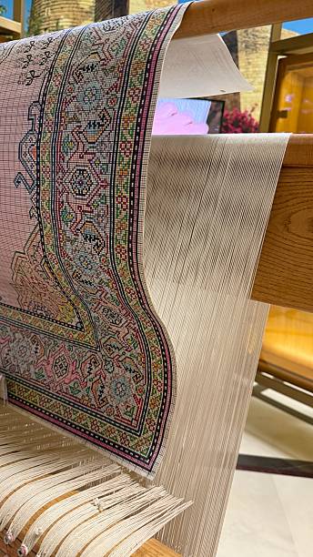 istock Carpet weaving loom with intricate design and threads in background 2248236614