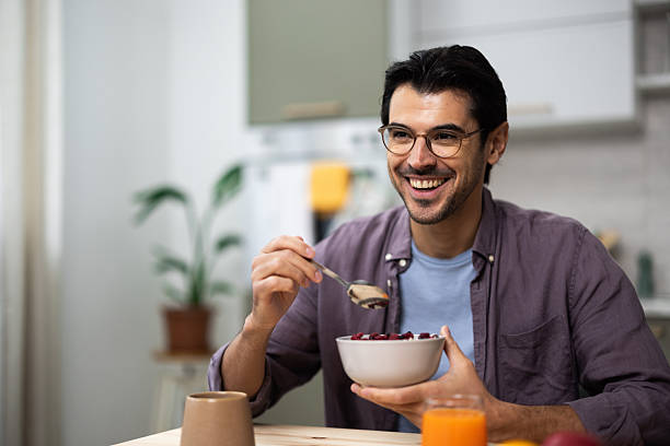 istock Happy man enjoying healthy breakfast cereal in kitchen 2248239025