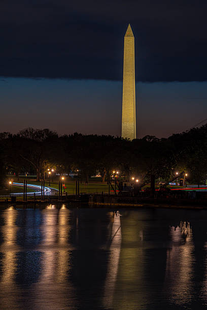 istock Washington Monument glows at dusk over reflective water 2248239268