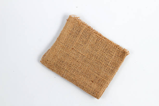 istock piece of rustic jute burlap fabric on a clean white background. 2248240181