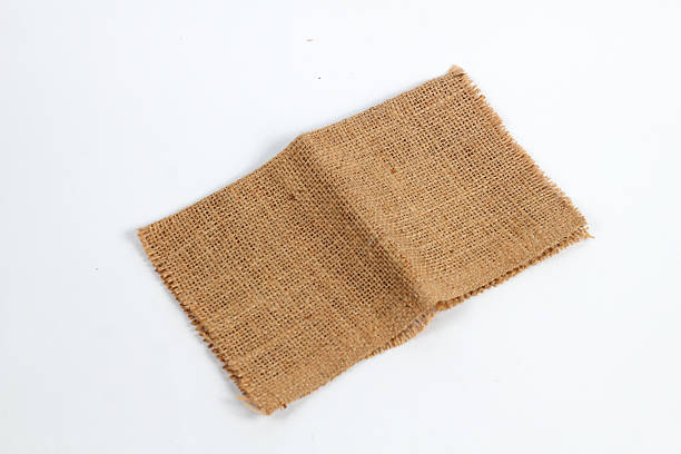 istock piece of rustic jute burlap fabric on a clean white background. 2248240184