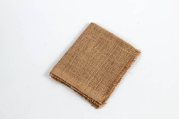 istock piece of rustic jute burlap fabric on a clean white background. 2248240243