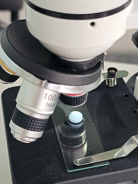 istock Close view of a microscope focusing on a glass slide with a specimen under examination for scientific study concept 2248241913