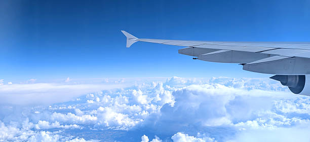 istock white clouds from passenger plane flying at over 40000 feet with visible wing 2248242502