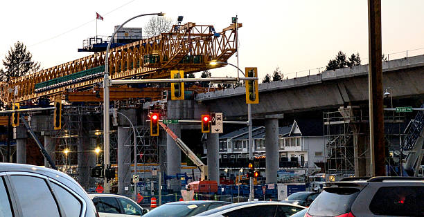 Surrey, Canada - November 13, 2025: Looking west on the Fraser Highway at 152nd Street. A launching gantry positions the elevated guideways on tulip pillars above the Fraser Highway. The Fleetwood neighbourhood includes commercial and residential districts. The TransLink SkyTrain extension will connect King George Station in the west to Langley City Centre Station in the east. Autumn afternoon in Metro Vancouver.