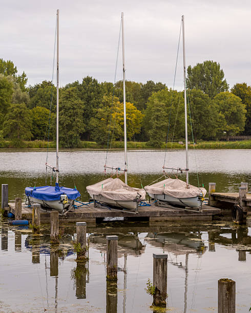 istock Sailboats resting on a wooden dock in serene lake setting 2248247059
