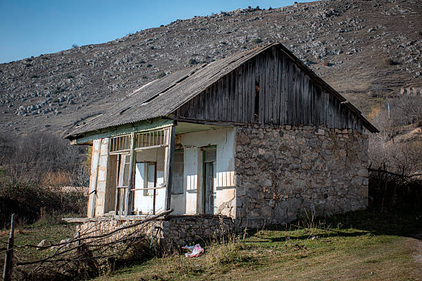 Rustic countryside house surrounded by hills. Ideal for rural life, isolation, simplicity, heritage.