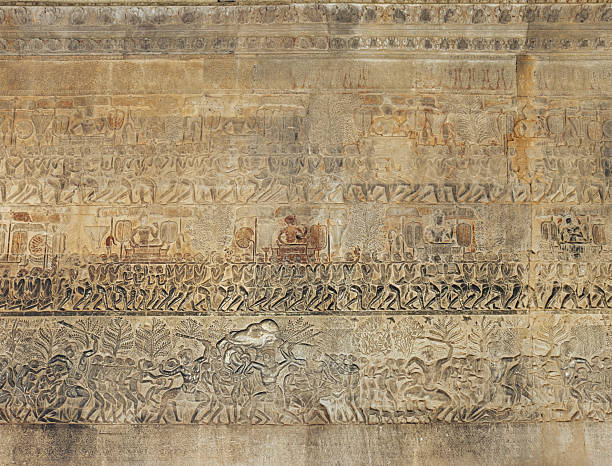 Magnificent stone carvings at Angkor Wat temple in Cambodia, showcasing traditional Khmer artistry with intricate warrior depictions and historical religious symbols.