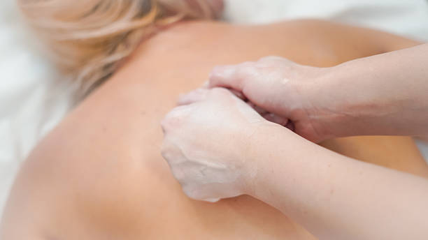 istock Gentle massage hands working on blonde client creating calm salon atmosphere 2248249322