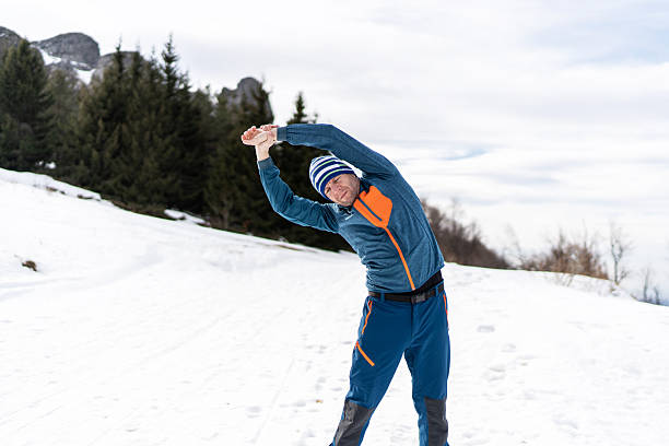 istock Man stretching during winter mountain hike training 2248249360