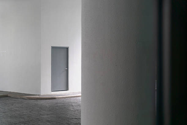 A gray building with a white gate