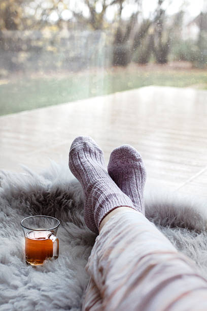 istock Relaxing at home with warm socks and a cup of tea 2248250279