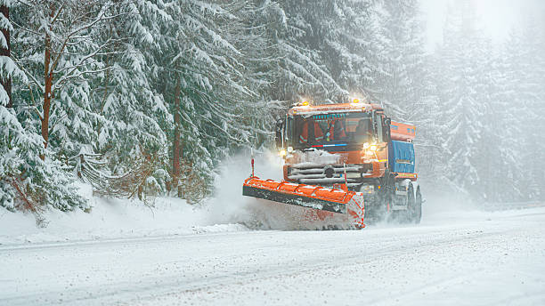 istock Snow plow clear and sprinkles snowy road in a snowstorm. 2248253052