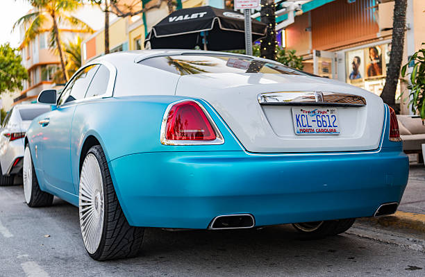 Miami, Florida, USA - April 08, 2025: Rolls Royce Wraith luxury grand tourer car. Grand tourer car Rolls Royce Wraith. Car Rolls Royce Wraith parked outdoor. White blue car, corner view.