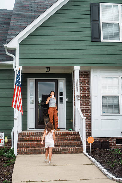 istock Mom Drinking Coffee on Front Porch as Daughter Plays Outside 2248253667