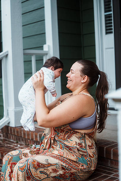istock Smiling Puerto Rican Mom Holding Her Baby 2248253732
